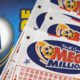 Photo of Mega Millions lottery tickets and logo