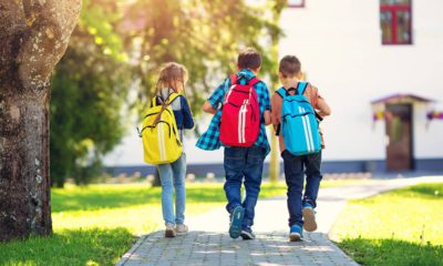 Photo of 3 children walking to school